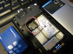 Slip the SD card in the slot in that circuled area.