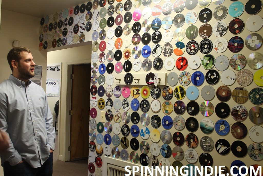 Station Manager and wall of CDs at WONC