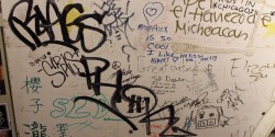 graffiti and signature-covered wall at college radio station KWVA