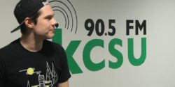 KCSU General Manager Sam Bulkley in front of college radio station's logo. Photo: J. Waits