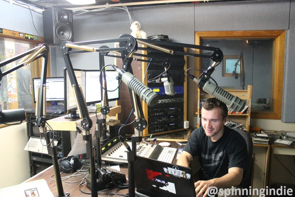 DJ in Radio 1190's on-air studio. Photo: J. Waits