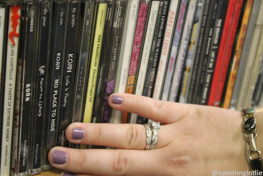 Abbey Bailey shows off the station's collection of Korn CDs. Photo: J. Waits