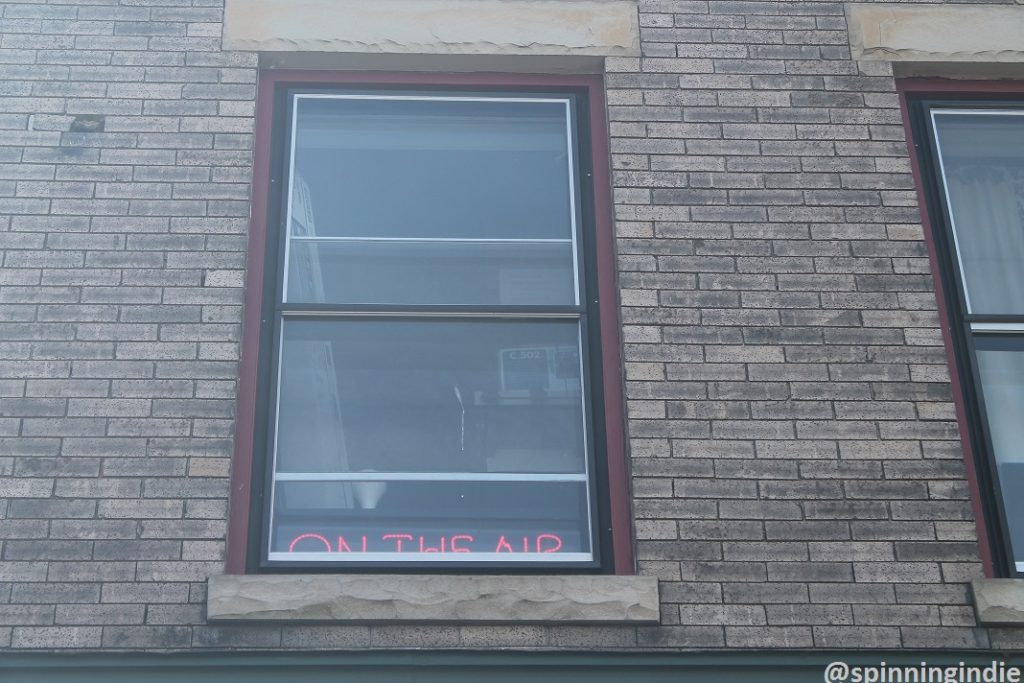 On-air sign in window of community radio station WRIR-LP. Photo: J. Waits