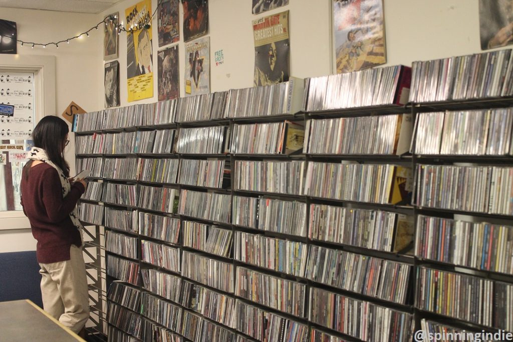 Student peruses CDs in the WCWM studio during her friend's college radio show. Photo: J. Waits