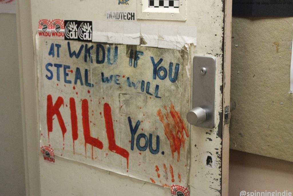 "WKDU if you steal, we will kill you" sign on the door to the college radio station. Photo: J. Waits