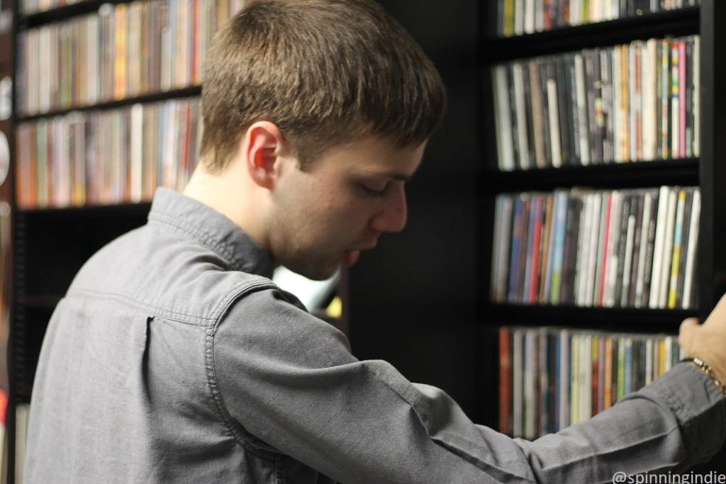 Soren Spicknall peruses CDs in WIIT music library. Photo: J. Waits