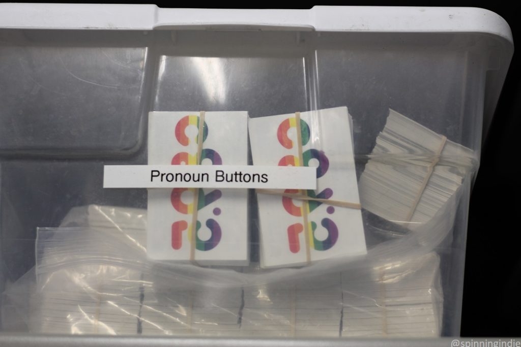 Bin marked "pronoun buttons" at KNHC with rainbow temporary tattoos. Photo: J. Waits