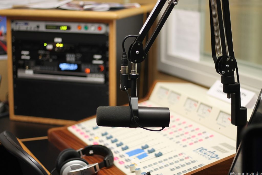 High school radio station KASB's on-air studio, with sound board, microphone, headphones, and rack of equipment. Photo: J. Waits/Radio Survivor