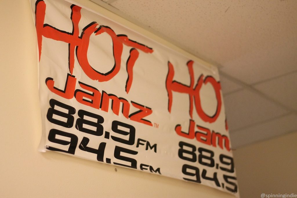 Old Hot Jamz 88.9 FM 94.5 FM banner on the wall at high school radio station KMIH.