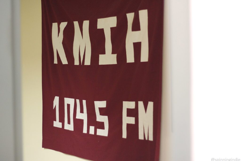 vintage high school radio station KMIH 104.5 banner hanging on the wall at Mercer Island High School. Photo: J. Waits/Radio Survivor