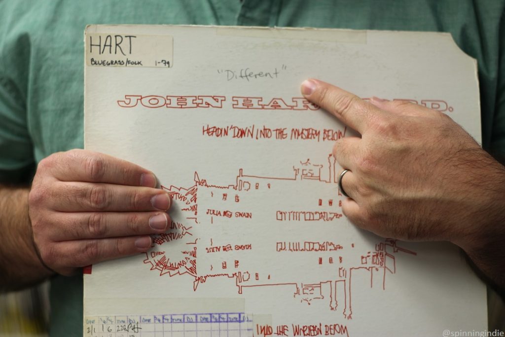 Music Director Iaan Hughes pointed to the word "different" written on a bluegrass LP cover in the KBCS library. Photo: J. Waits/Radio Survivor