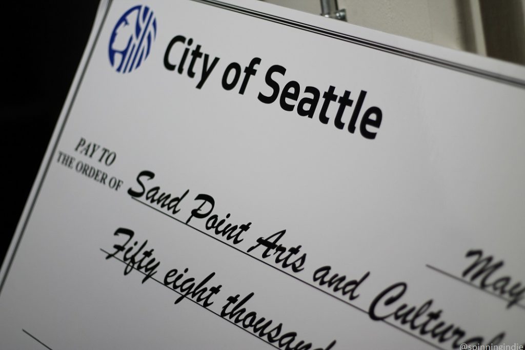 Large oversized poster of check from City of Seattle to Sand Point Arts and Cultural Exchange. Photo: J. Waits/Radio Survivor