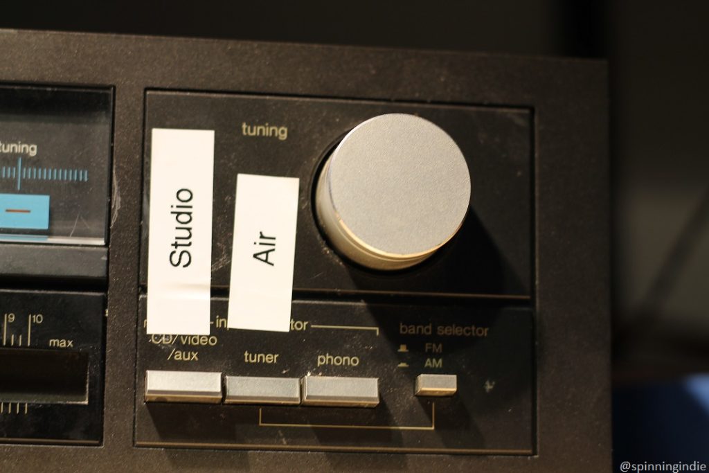 Audio equipment in community radio station KBFG's Shack labeled with "studio" and "air" next to a tuning dial and above a tuner button that has been pressed (next to the Air label). Photo: J. Waits/Radio Survivor