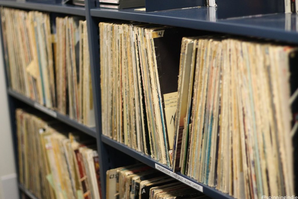 Shelves of LPs in Music Library at SDS radio's sister station KSDS-FM. Label on shelf reads "progressive/free jazz/avant garde." Photo: J. Waits/Radio Survivor