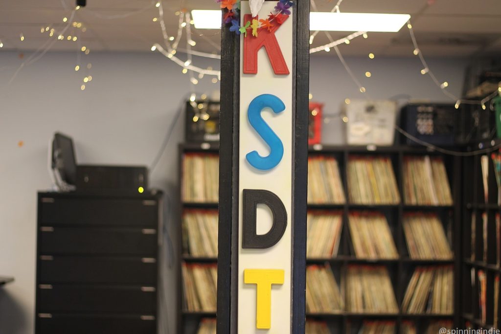 View from lobby into KSDT studio/record library. Pictured: Letters K, S, D,T on pillar with shelves of LPs in distance. Photo: J. Waits/Radio Survivor