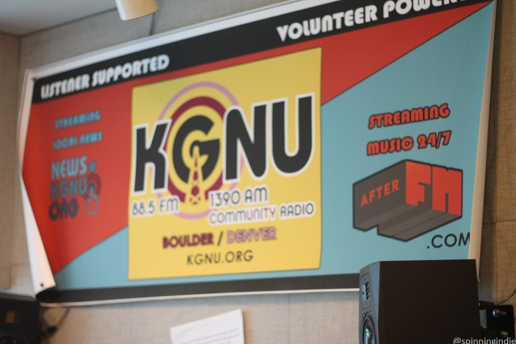 KGNU banner posted on the wall at the community radio station. Photo: J. Waits/Radio Survivor