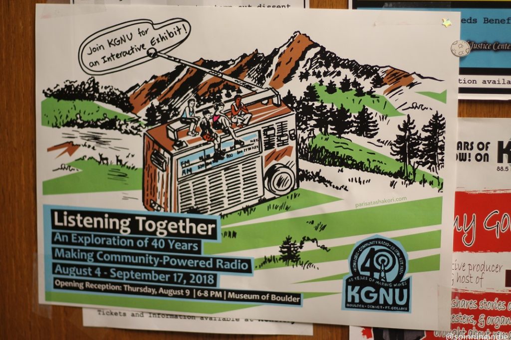 Flyer for KGNU's 40th anniversary "Listening Together" exhibit. Test reads: "Join KGNU for an interactive exhibit" and "Listening Together: An Exploration of 40 Years Making Community-Powered Radio August 4 - September 17, 2018." A drawing of a radio is at the center of the flyer, with a mountain range behind it. Photo: J. Waits/Radio Survivor