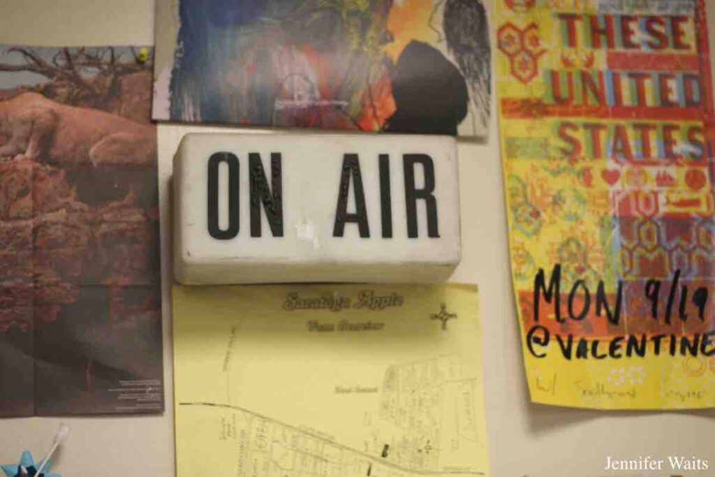 At college radio station WCDB: wall with ON AIR sign, posters and flyers. Photo: J. Waits