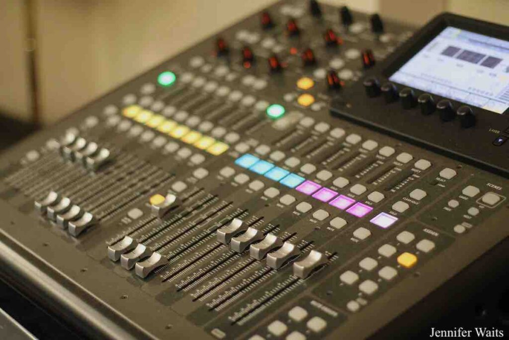 Photo of board at college radio station BSR. Buttons are illuminated in purple, blue, yellow and green. Photo: J. Waits