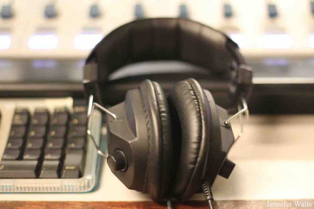 Photo at college radio station BSR. Pictured is a pair of black headphones next to a computer keyboard. Photo: J. Waits