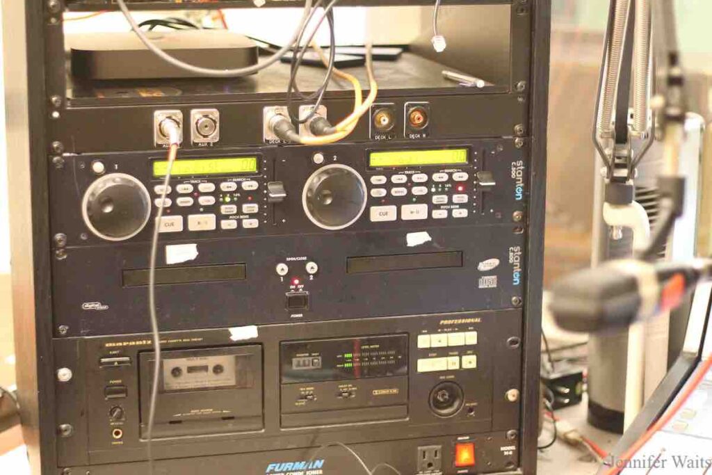 Photo of rack of CD players and cassette decks at college radio station BSR in 2023. Photo: J. Waits