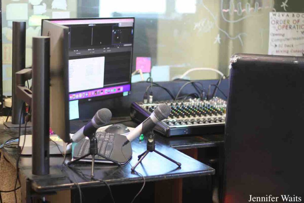 Studio at college radio station WSVA in March, 2023. In the photo are two microphones, a computer monitor, mixing board. Photo: J. Waits