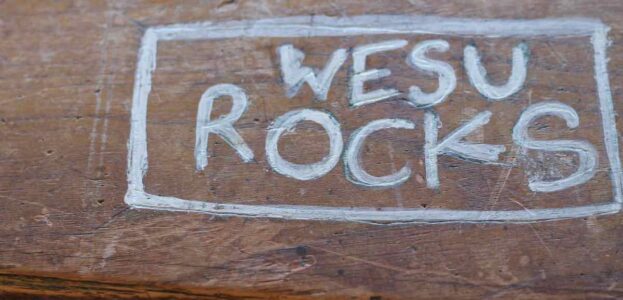 Radio Station Visit #190: WESU-FM at Wesleyan University Photo of the phrase "WESU ROCKS" written in silver marker on a wooden table at the college radio station at Wesleyan University. Photo: J. Waits