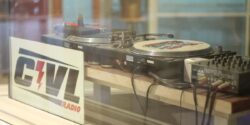 Photo of CIVL radio station shows window with CIVL sign and turntables behind glass. Photo: J. Waits