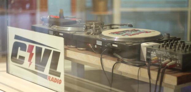 Photo of CIVL radio station shows window with CIVL sign and turntables behind glass. Photo: J. Waits
