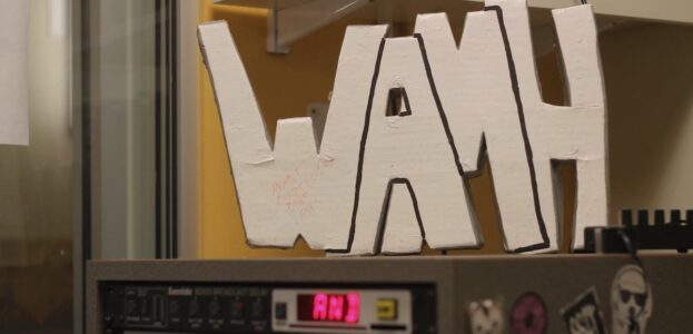 Radio Station Visit #199: WAMH-FM at Amherst College Photo of WAMH sign perched atop audio equipment in the Amherst College radio station WAMH. Photo: J. Waits