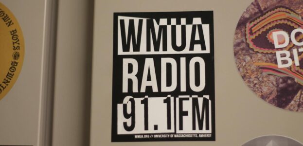 Photo of WMUA Radio 91.1 FM black and white sticker affixed to a metal cabinet at the UMass Amherst college radio station. Photo: J. Waits
