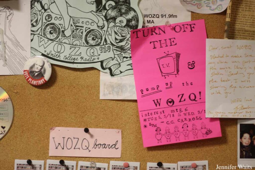 Photo of flyers on a bulletin board at college radio station WOZQ. photo by J. Waits